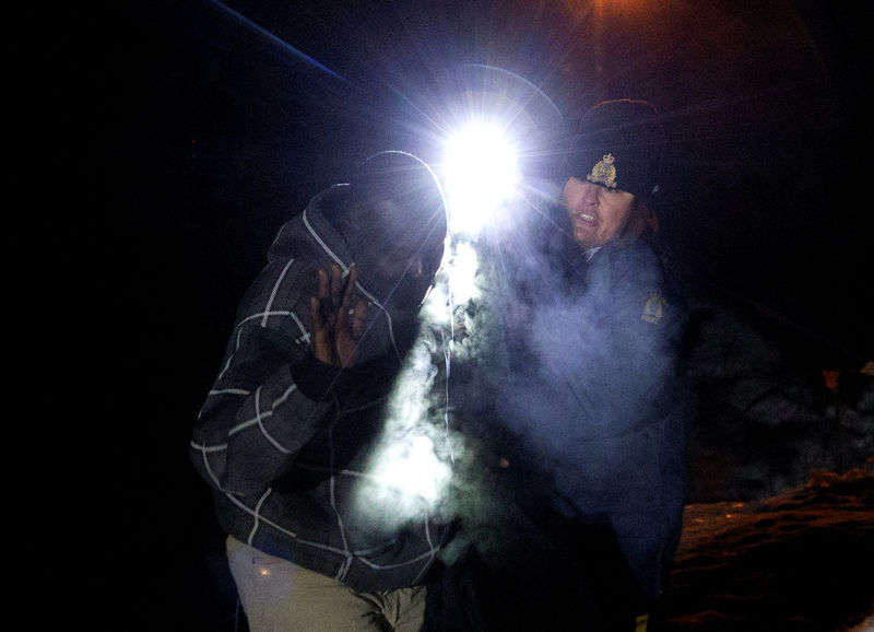 © Reuters. A Picture and Its Story: "I just want to be safe" - crossing into Canada