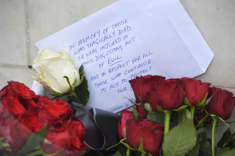 © Reuters. Flowers are left outside New Scotland Yard the morning after an attack in London