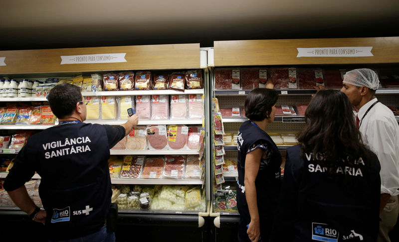 © Reuters. A member of the Public Health Surveillance Agency measures the temperature where the products are exposed, at a supermarket in Rio de Janeiro