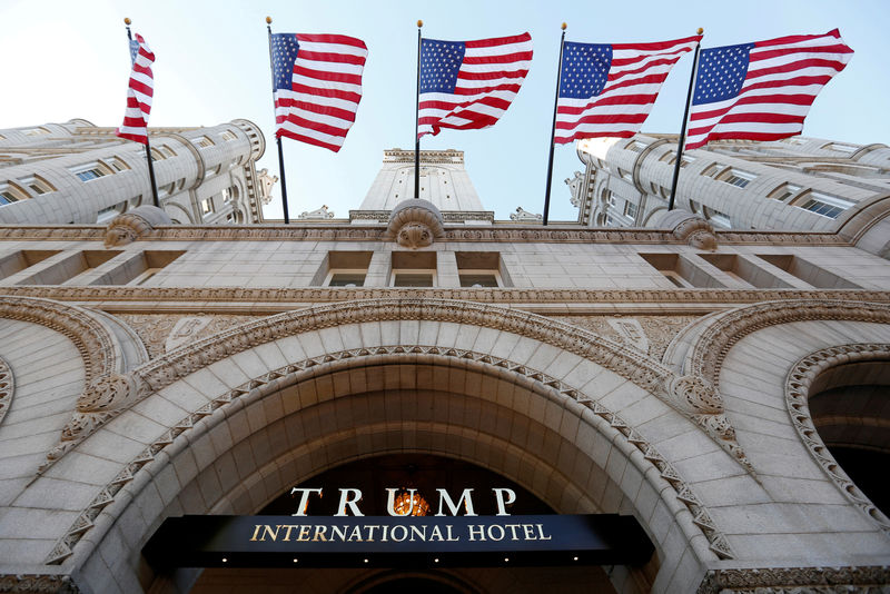 © Reuters. FILE PHOTO - Flags fly above the entrance to the new Trump International Hotel on its opening day in Washington