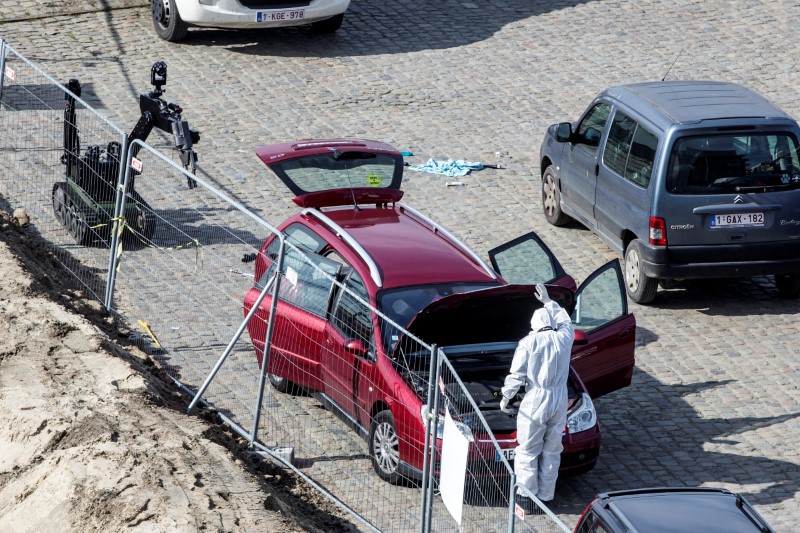 © Reuters. A forensics expert stands next to a car which had entered the main pedestrian shopping street in the city at high speed, in Antwerp
