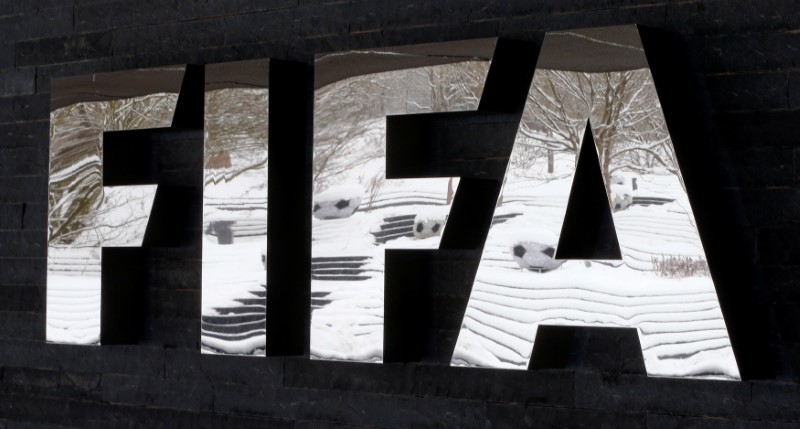 © Reuters. Snow-covered landscape is reflected in a logo in front of FIFA headquarters in Zurich