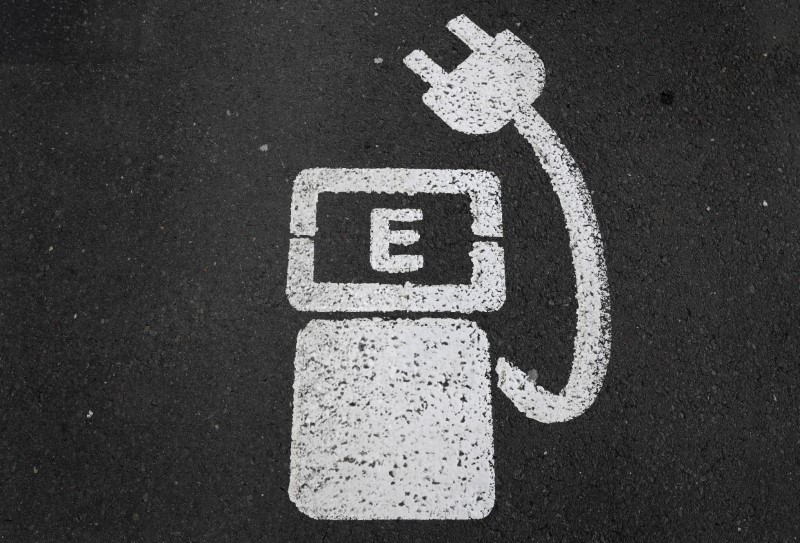 © Reuters. File photo of a battery charger sign for electric cars painted on the ground of a parking ground near the soccer stadium in Wolfsburg