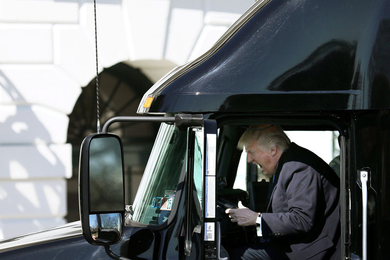 © Reuters. U.S. President Donald Trump reacts as he sits on a truck while he welcomes truckers and CEOs to attend a meeting regarding healthcare at the White House in Washington, U.S.