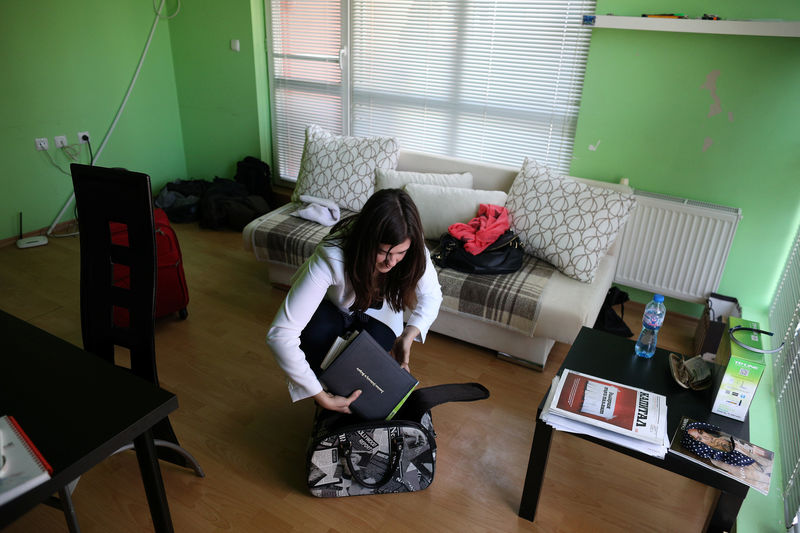 © Reuters. Bulgarian Yolcheva, a PR professional, prepares her luggage prior to her departure to London, in Sofia