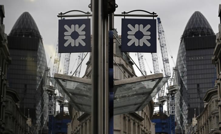 © Reuters. A logo of the Royal Bank of Scotland (RBS) is reflected in the window of a branch office in London