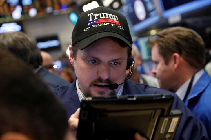 © Reuters. A trader wears a Donald Trump hat while working on the floor of the NYSE shortly after the opening bell in New York