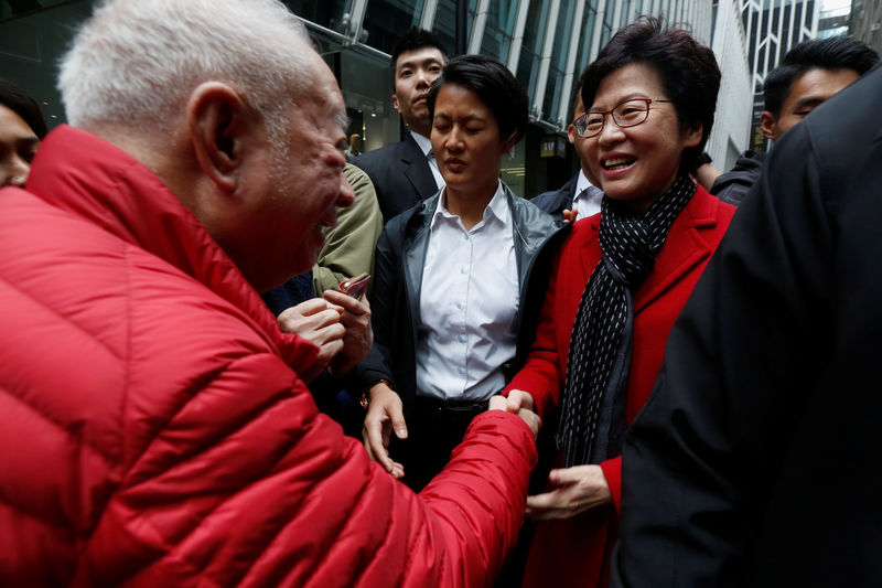 © Reuters. A man shakes hands with Carrie Lam, chief executive-elect, a day after she was elected in Hong Kong