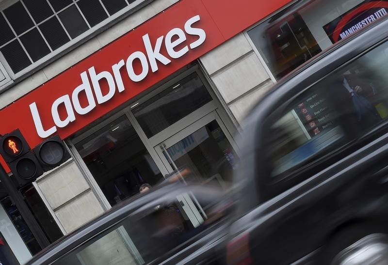 © Reuters. Shaddick, Head of Political Betting at Ladbrokes poses at a branch of Ladbrokes in central London, Britain