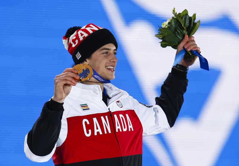 © Reuters. Bronze medalist Mark McMorris of Canada celebrates during the medal ceremony for the men's snowboard slopestyle competition in the Olympic Plaza at the 2014 Sochi Olympic Games