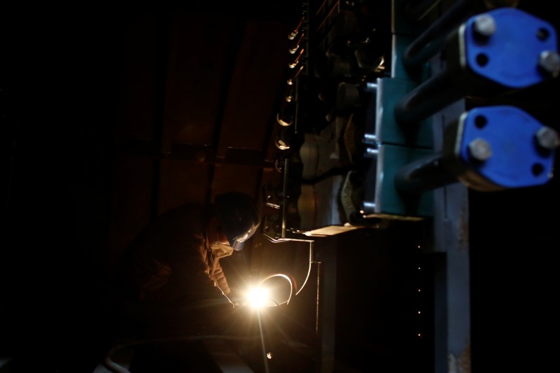 © Reuters. File photo: A man works in the Tianye Tolian Heavy Industry Co. factory in Qinhuangdao