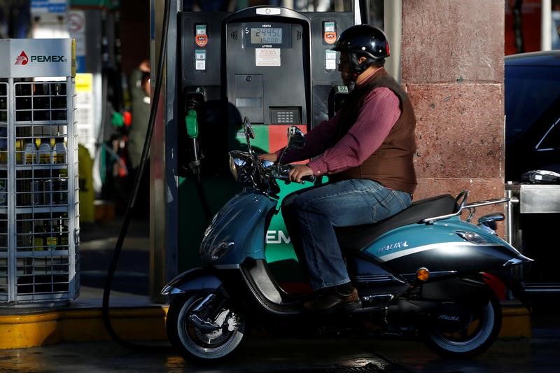 © Reuters. A motorcyclist is seen next to fuel pumps at a Pemex gas station in Mexico City