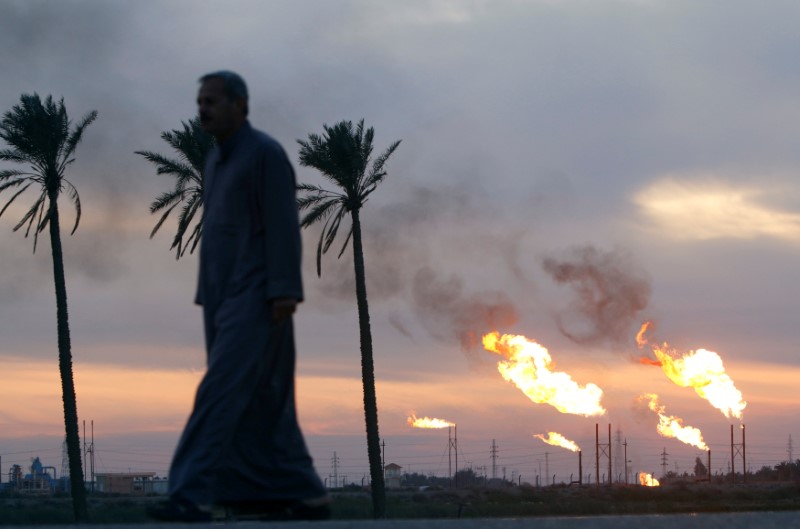 © Reuters. FILE PHOTO:  Flames emerge from flare stacks at the oil fields in Basra