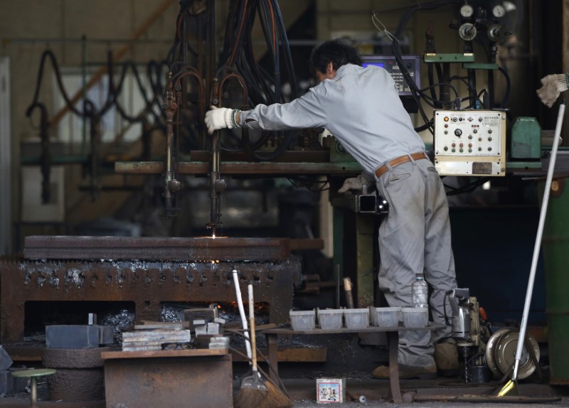 © Reuters. A man works around a metal procession machine at a factory in Urayasu