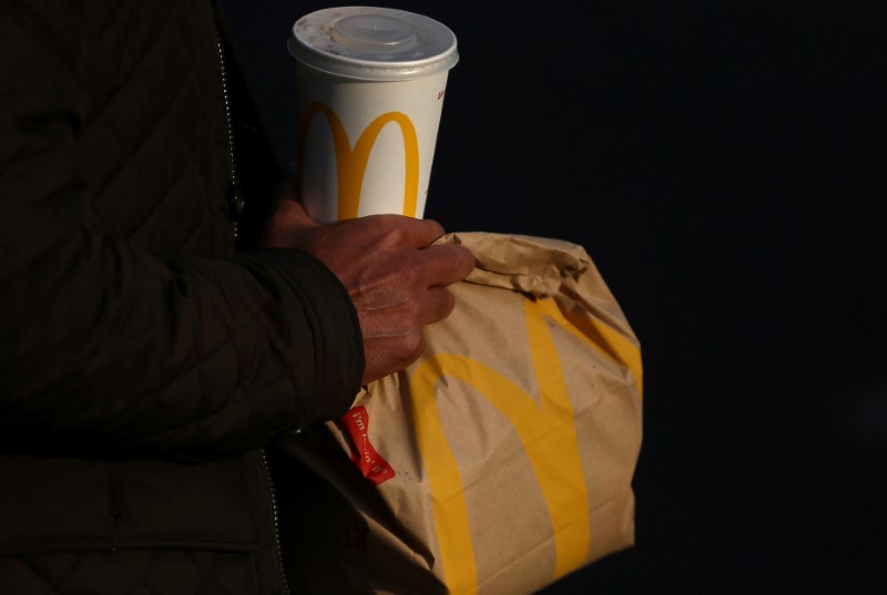 © Reuters. A man carries branded McDonald's purchases in London