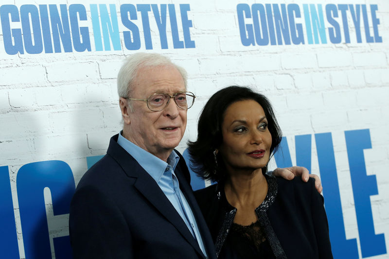 © Reuters. Actor Michael Caine and his wife Shakira pose as they arrive at the premiere of the film 'Going In Style' in New York City