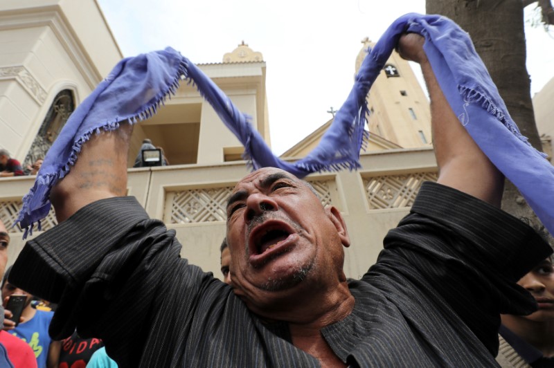 © Reuters. A relative of one of the victims reacts after a church explosion killed at least 21 in Tanta