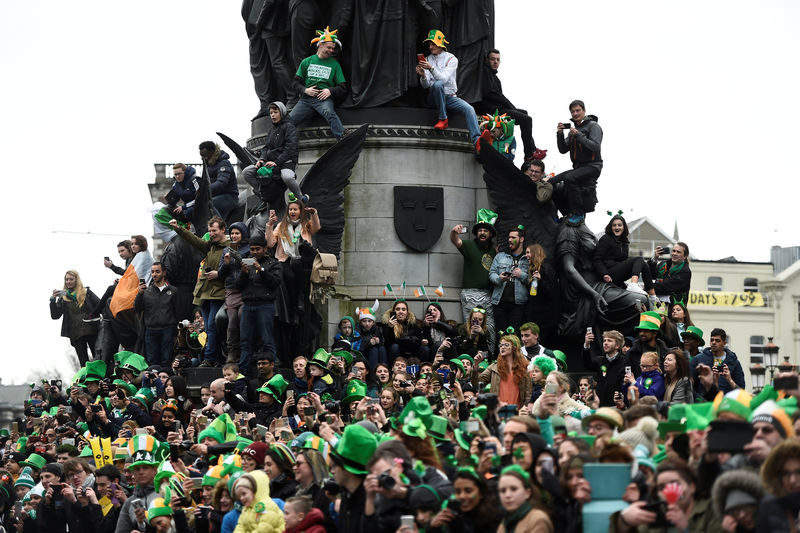 © Reuters. FILE PHOTO: People watch the St. Patrick's day parade in Dublin