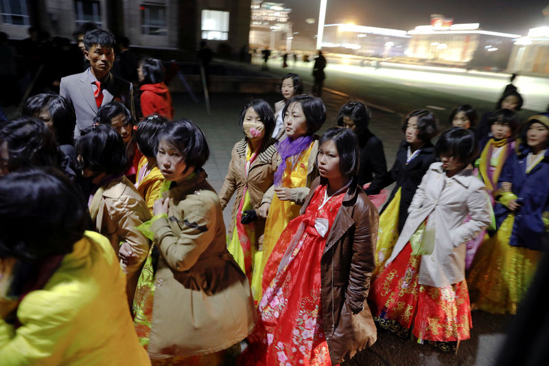© Reuters. Women dressed in traditional costumes walk near the main Kim Il Sung square in central Pyongyang