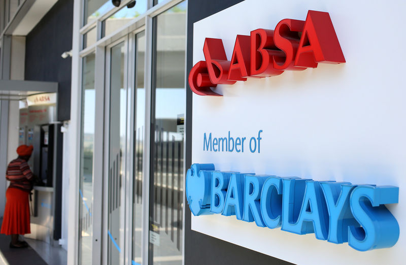 © Reuters. FILE PHOTO: A woman uses an ATM at a branch of Barclays South African subsidiary Absa bank
