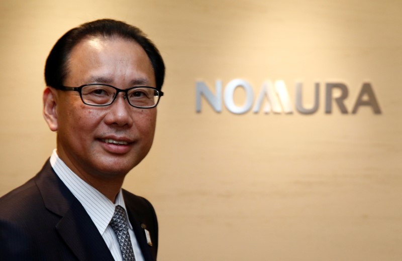 © Reuters. Nomura Holdings president Toshio Morita poses in front of his company's logo prior to an interview with Reuters in Tokyo