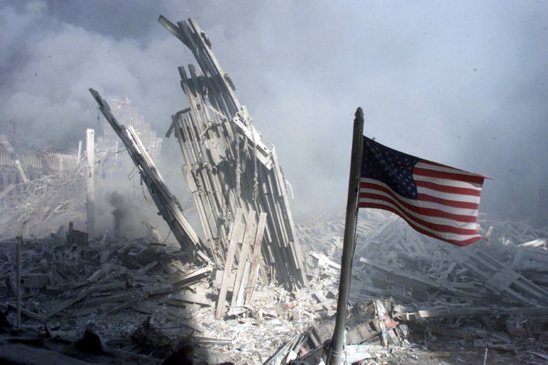 © Reuters. An American flag flies near the base of the destroyed World Trade Center in New York, September 11, ..