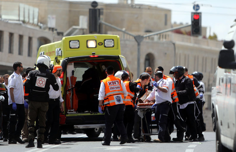 © Reuters. Israeli medics evacuate an injured person following a stabbing attack just outside Jerusalem's Old City, according to Israeli police