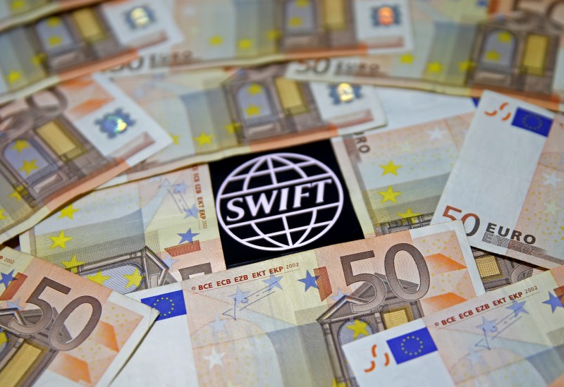 © Reuters. FILE PHOTO: Swift code bank logo is displayed on an iPhone 6s among Euro banknotes in this picture illustration