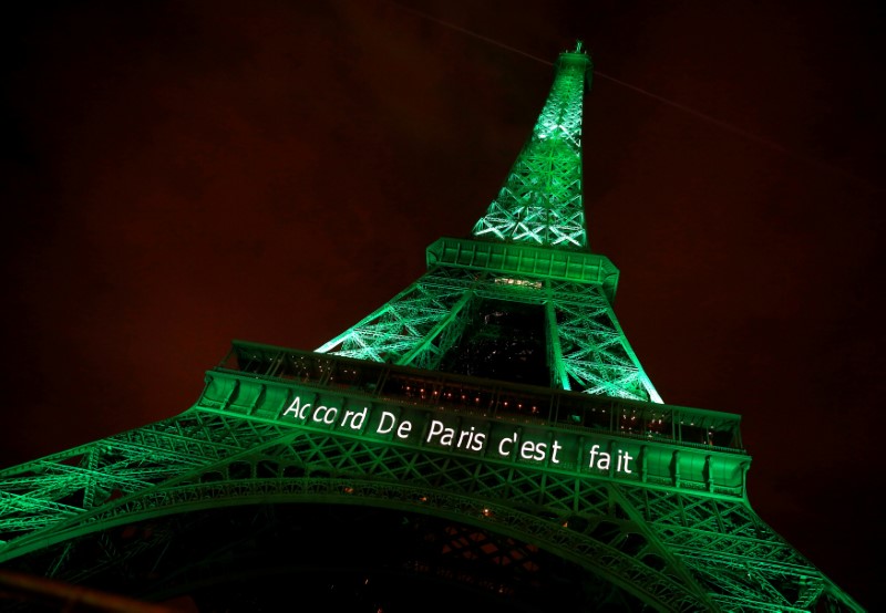 © Reuters. The Eiffel tower is illuminated in green with the words "Paris Agreement is Done", to celebrate the Paris U.N. COP21 Climate Change agreement in Paris