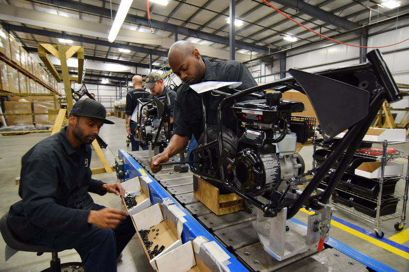 © Reuters. Workers construct mini-bikes at motorcycle and go-kart maker Monster Moto in Ruston