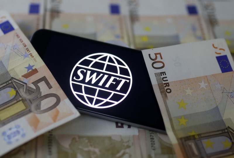 © Reuters. Swift code bank logo is displayed on an iPhone 6s on top of Euro banknotes in this picture illustration made in Zenica