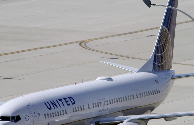 © Reuters. A United Airlines plane with the Continental Airlines logo on its tail, sits at a gate at O'Hare International airport in Chicago