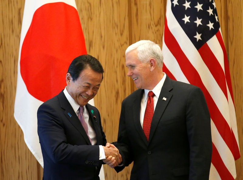 © Reuters. U.S. Vice President Mike Pence is welcomed by Japan's Deputy Prime Minister Taro Aso at the prime minister Shinzo Abe's official residence in Tokyo