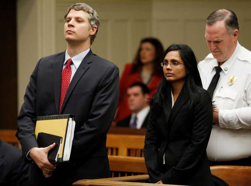 © Reuters. FIE PHOTO: Dookhan, a former chemist at the Hinton State Laboratory Institute, stands beside her lawyer Gordon during her arraignment at Brockton Superior Court in Brockton, Massachusetts