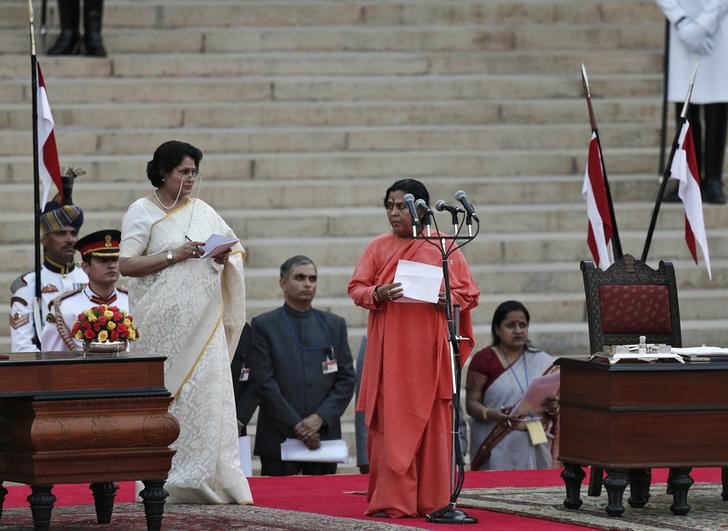 © Reuters. FILE PHOTO - Bharti is administered oath of office by India's President Mukherjee as a cabinet minister at the presidential palace in New Delhi