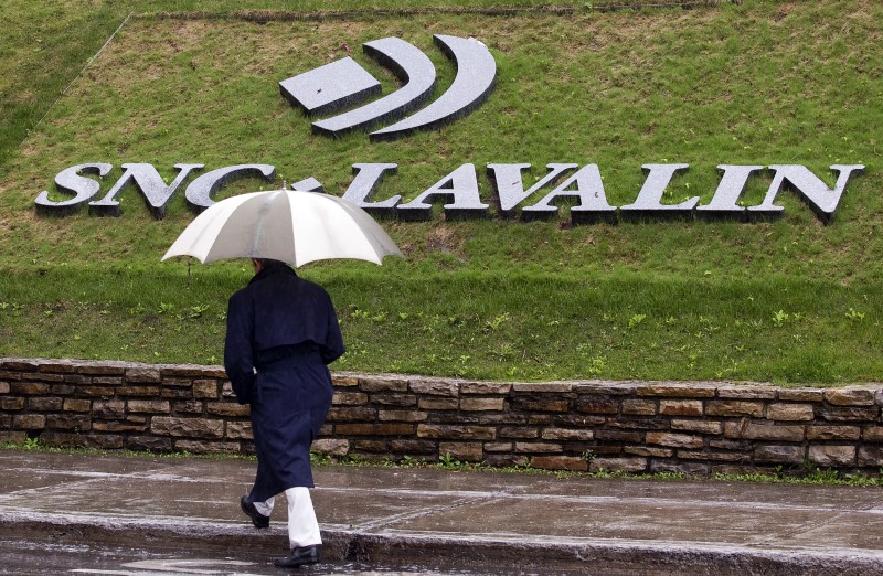 © Reuters. A pedestrian walks past the SNC-Lavalin Group Inc., headquarters in Montreal