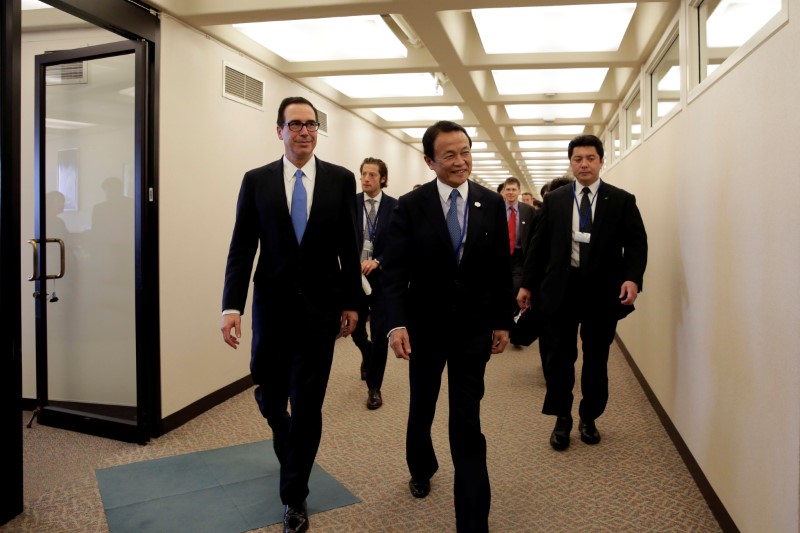 U.S. Treasurу Secretarу Steven Mnuchin and Japanese Finance Minister Taro Aso walk after their meeting during the IMF/World Bank spring meetings in Washington
