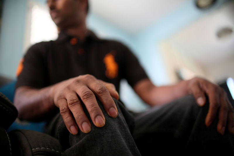 © Reuters. Raj, an immigrant from Sri Lanka, sits in his apartment in San Diego