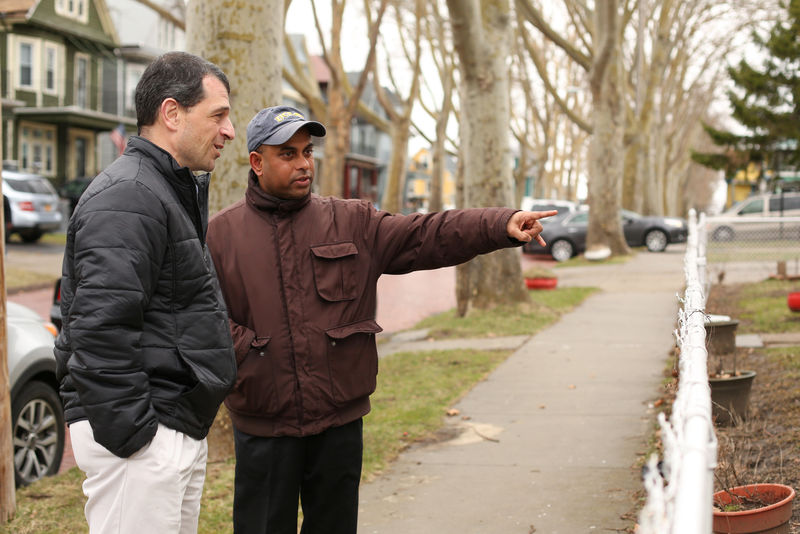 © Reuters. MD Chowdhury stands with Tom Muscarella of the Erie County Health Department and points to improvements made to his lead contaminated home during an interview in Buffalo