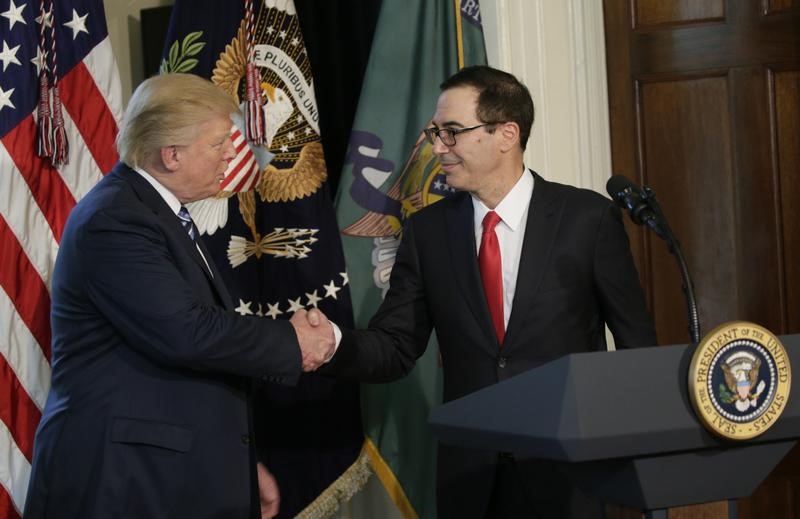 © Reuters. U.S. President Trump greets Treasury Secretary Mnuchin during signing financial services executive orders signing ceremony at the Treasury Department in Washington