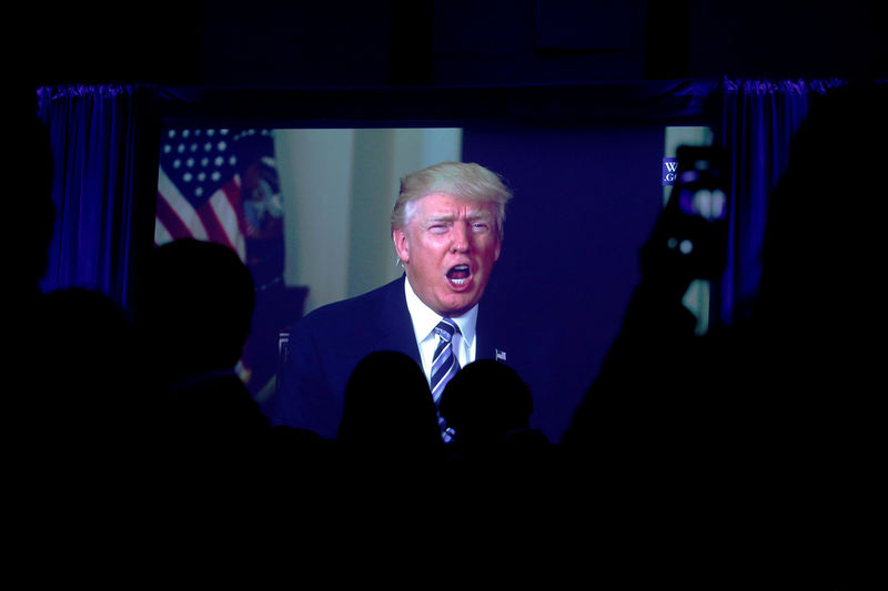 © Reuters. Guests watch a video of Trump as he addresses the 15th Plenary Assembly of the World Jewish Congress in New York