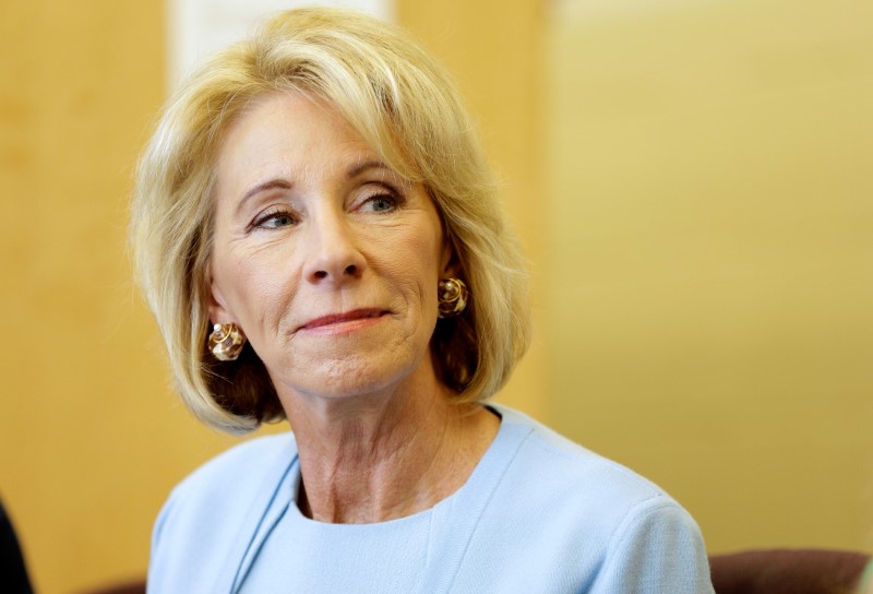 © Reuters. U.S. Secretary of Education Betsy DeVos listens to a presentation during a visit to the Excel Academy public charter school in Washington