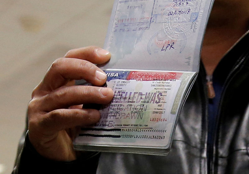 © Reuters. FILE PHOTO: A member of the Al Murisi family, Yemeni nationals who were denied entry into the U.S. last week because of the recent travel ban, show the cancelled visa in their passport at Washington Dulles International Airport in Chantilly