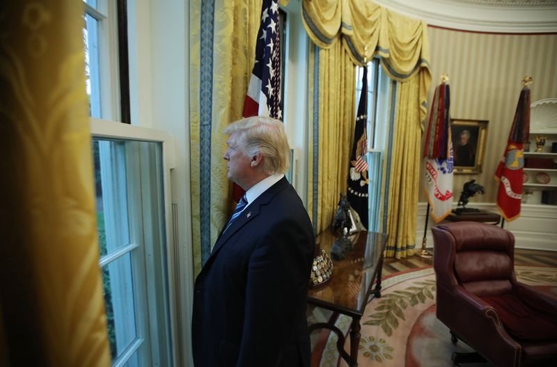 © Reuters. U.S. President Donald Trump looks out window of the Oval Office following an interview with Reuters at the White House in Washington