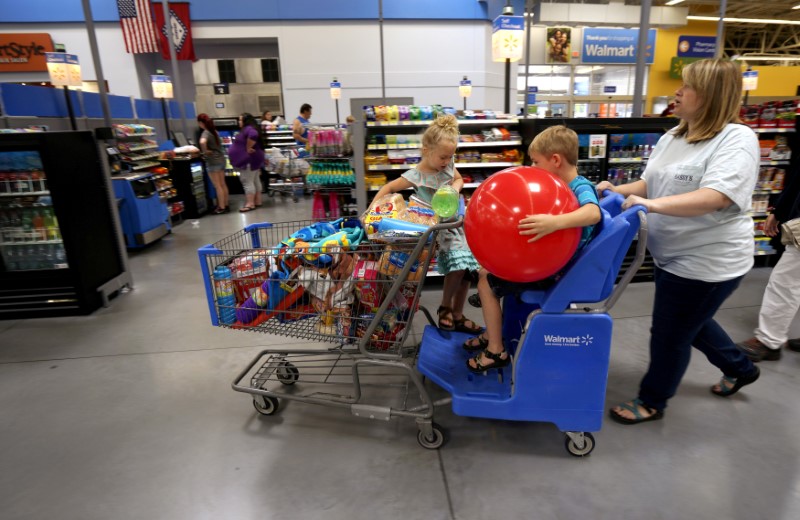 © Reuters. FILE PHOTO: A family shops at the Wal-Mart Supercenter in Springdale