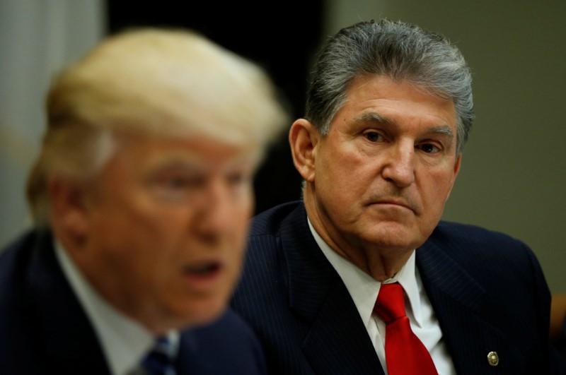 © Reuters. West Virginia Democrat Sen. Joe Manchin looks towards U.S President Donald Trump during a Supreme Court listening session at the White House in Washington