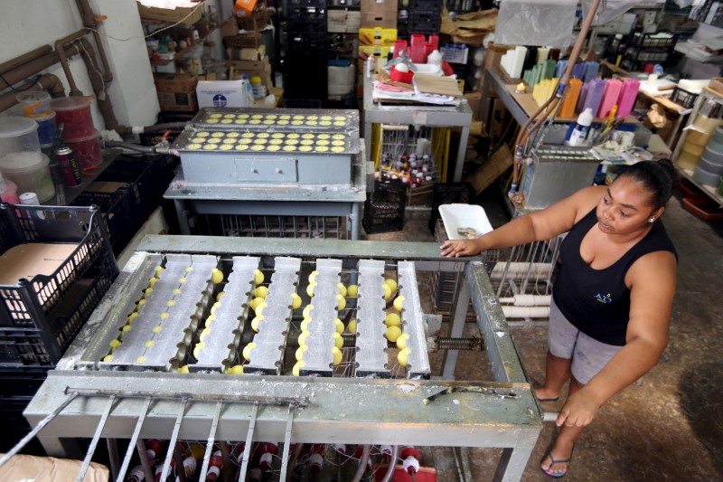 © Reuters. A woman works in a factory of citronella candles in Sao Joao da Boa Vista, Brazil