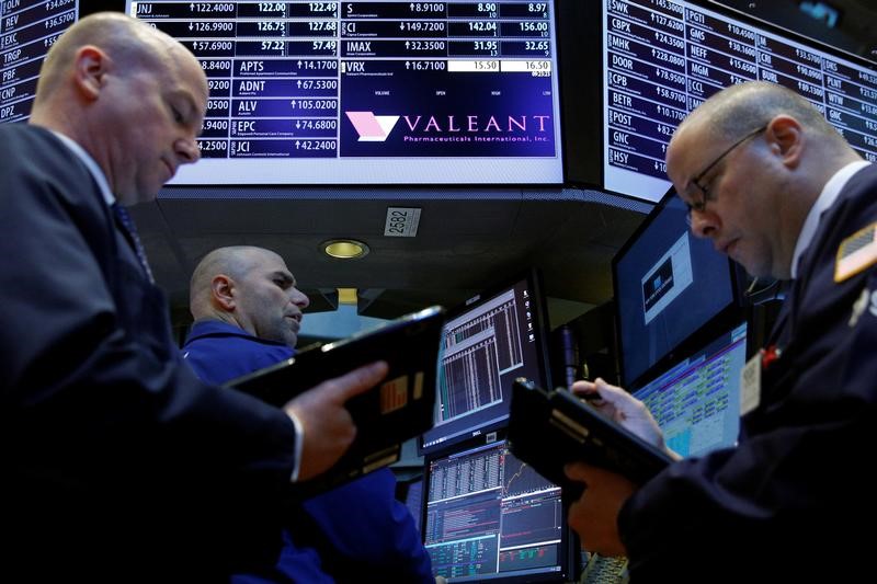 © Reuters. Traders gather at the post where Valeant Pharmaceuticals is traded on the floor of the NYSE