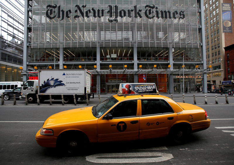 © Reuters. FILE PHOTO: A taxi passes by in front of The New York Times head office in New York