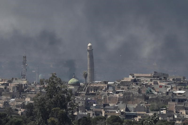 © Reuters. حقائق- المعارك تستعر في الموصل والخطر يقترب من المئذنة المائلة بجامع النوري